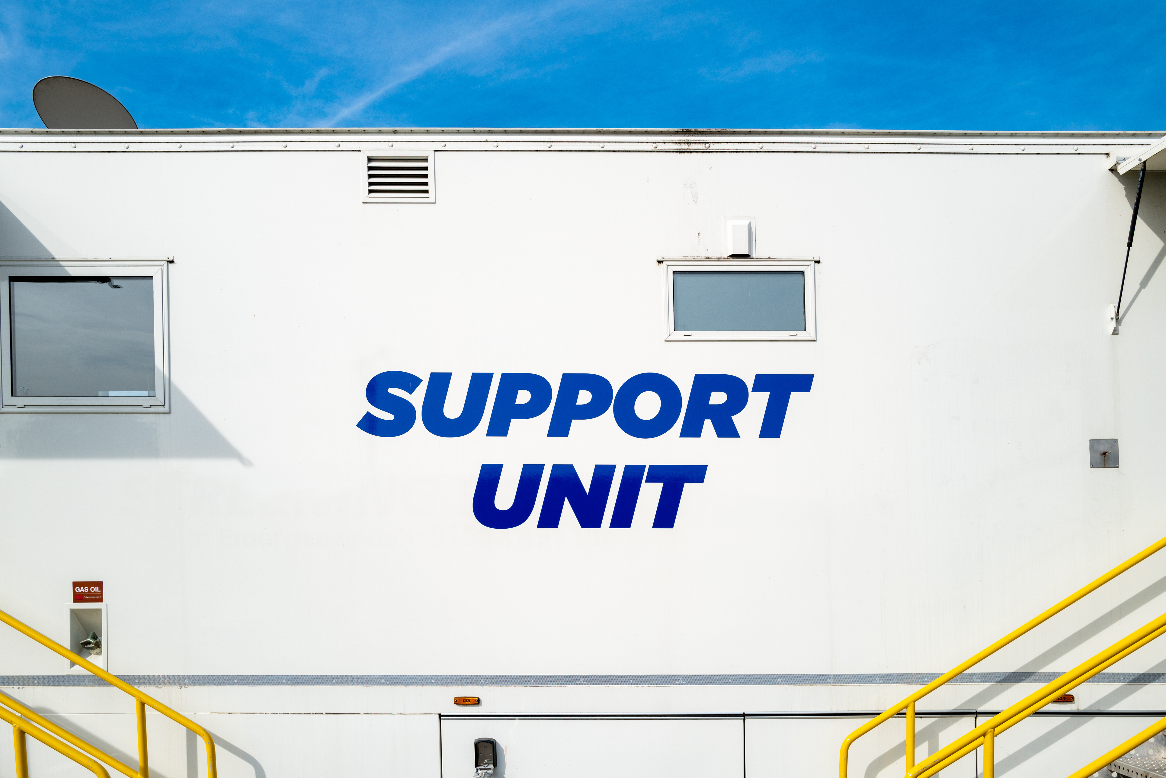 Large mobile cancer screen unit showing the support unit screening trailer and yellow hand rails to allow patients to board