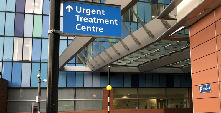 A sign outside a hospital directing patients to an urgent treatment centre
