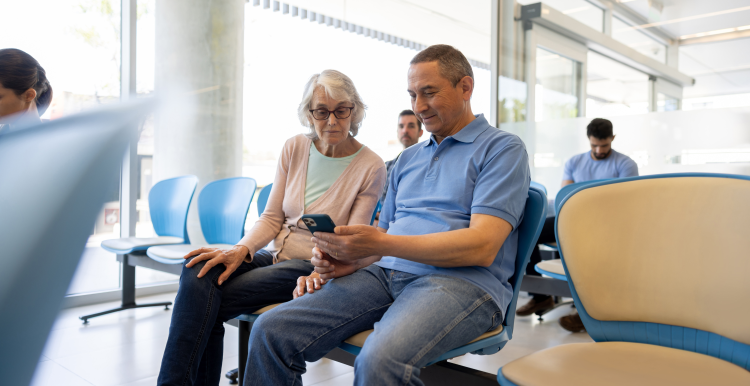 Husband and wife sat in a hospital waiting area