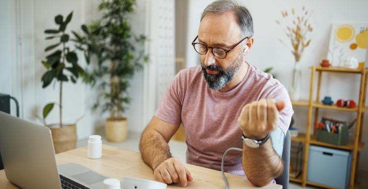A person taking their own blood pressure.