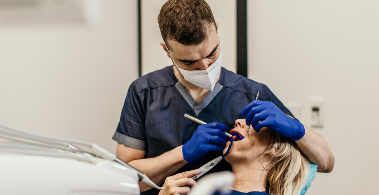 A dentist performing a check-up on a patient.