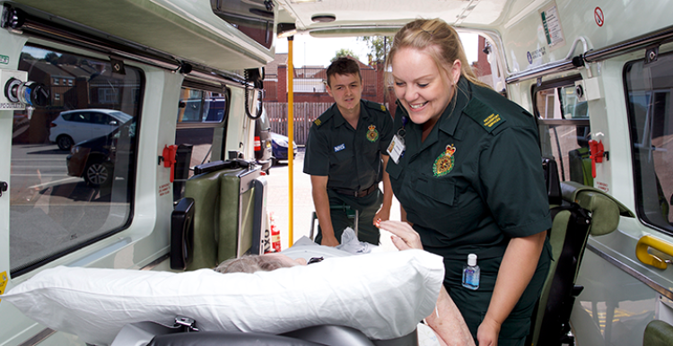 Patient transport service staff with a patient.