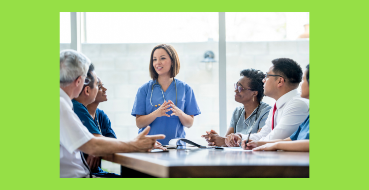 Physician associates and doctors sat around a table talking