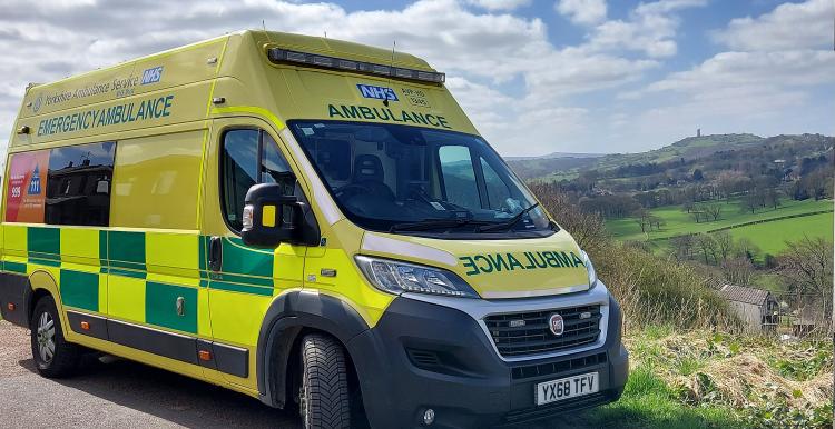 An ambulance pulled up in a rural location.