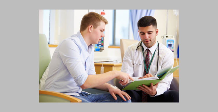 A doctor talking to a patient at a GP practice.