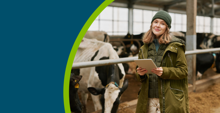 A female farmer stood in a cow shed