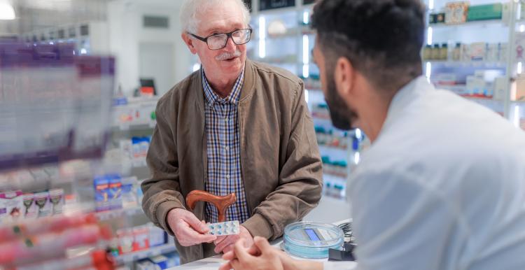 Young pharmacist explaining to customer how to be dosing medication
