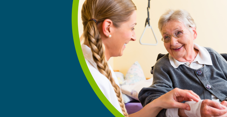 A healthcare professional helping an older lady with a bandage on her wrist in a social care setting.