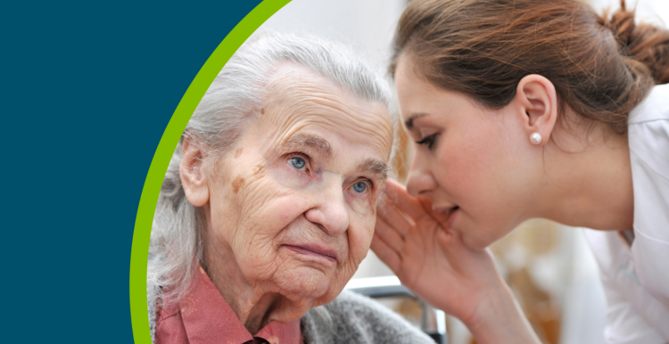 Female nurse is speaking in senior woman ear