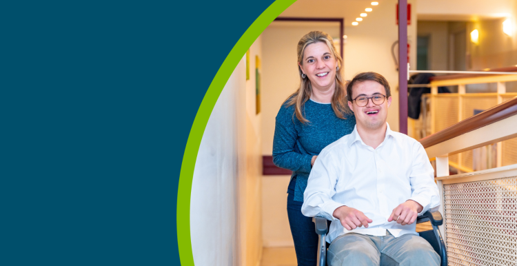 Happy portrait of a caregiver and man with down syndrome on wheelchair