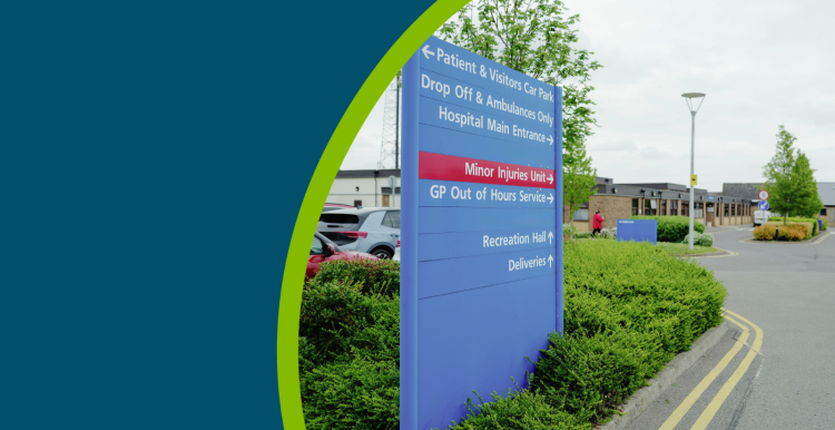Hospital sign pointng toward patient and visitors car park, drop off, main hospital entrance, minor injuries unit, GP out of hours service
