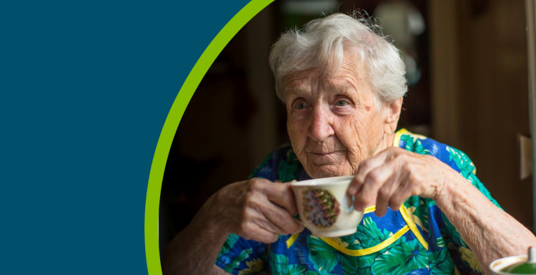 Elderly woman drinking a cup of tea alone.