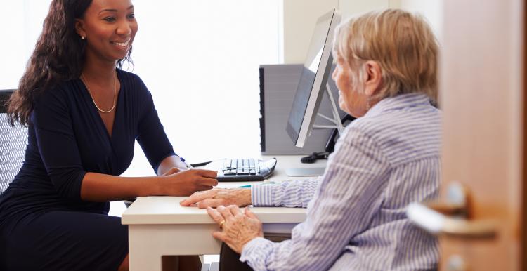 Older female patient having consultation with a female doctor at a GP practice