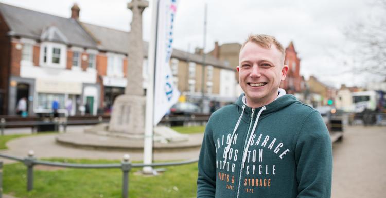 man stood in market square at healthwatch event