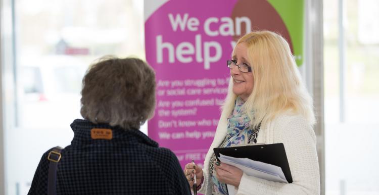 two people stood talking at a healthwatch event