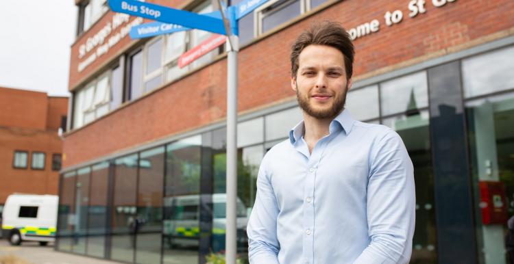 A man standing outside a hospital