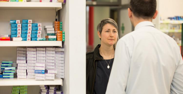 woman speaking to pharmacist