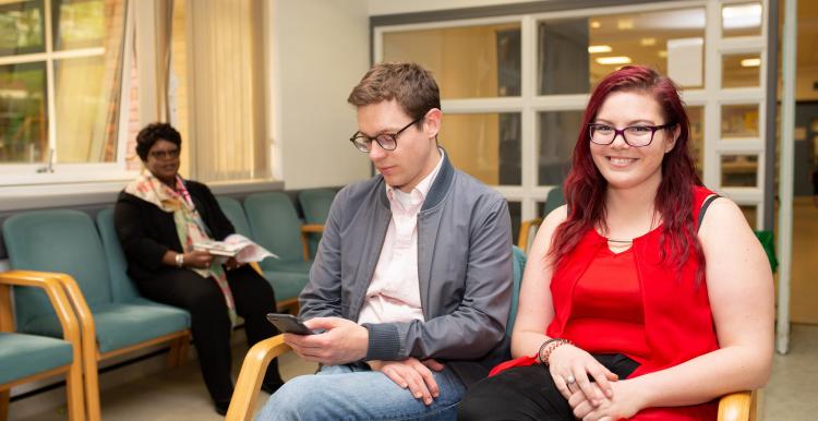 Two people sitting in a waiting room