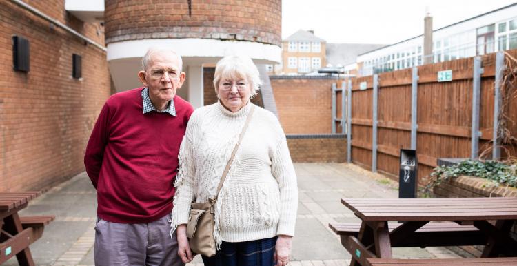 elderly couple stood together