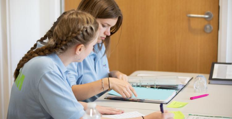 Two young female volunteers working together