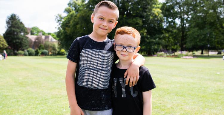 Two young boys with their arms round each other