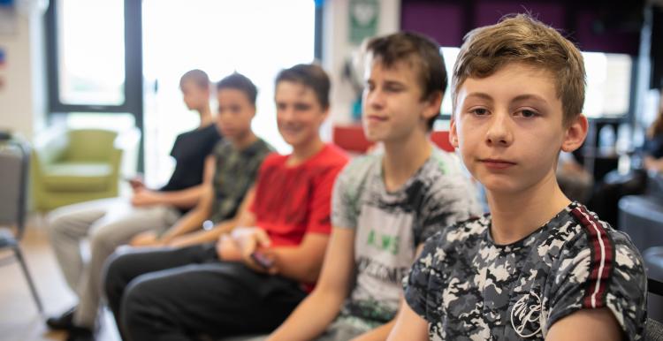 Group of young boys sitting in a row