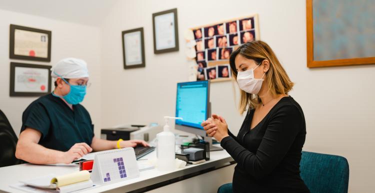 photo of person with medical professional with face mask on