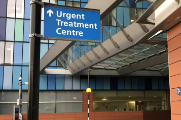 A sign outside a hospital directing patients to an urgent treatment centre