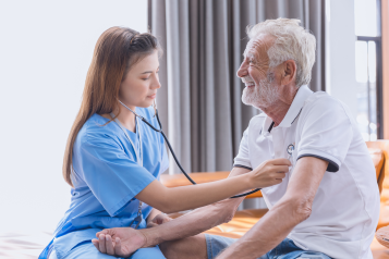 A doctor listening to a patient's heart.