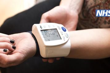 Someone taking their blood pressure.