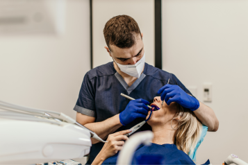 A dentist performing a check-up on a patient.