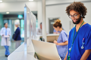 A healthcare professional at a hospital reception area