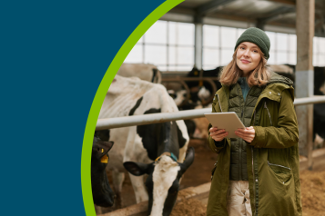 A female farmer stood in a cow shed