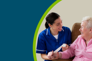 An older woman in a care home with a nurse putting a bandage on her wrist