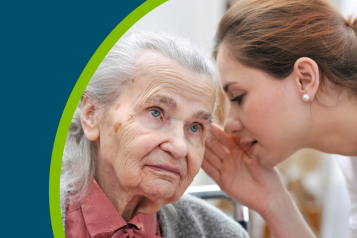 Female nurse is speaking in senior woman ear
