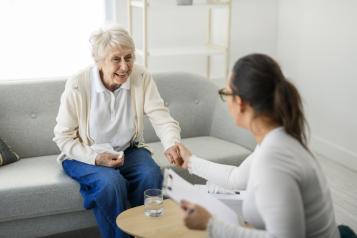 Old woman talking with a healthcare professional in a GP practice