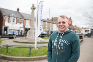 man stood in market square at healthwatch event