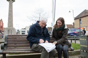 two people sat on bench at healthwatch event