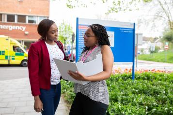 two people stood outside hospital talking