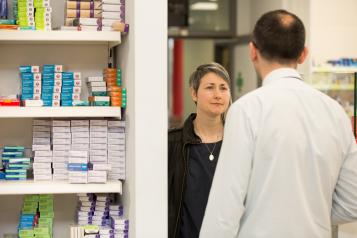 woman speaking to pharmacist