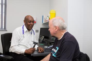 man in room with doctor