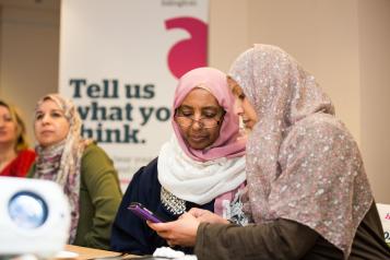 two women speaking at hw meeting