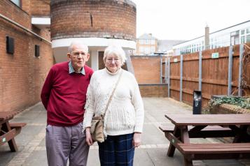 elderly couple stood together