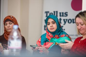 woman at healthwatch event listening to speaker