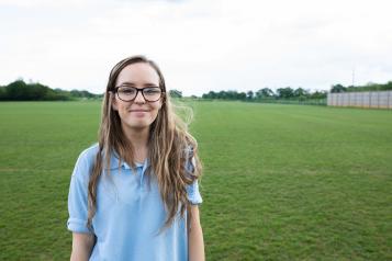 Young volunteer smiling at the camera