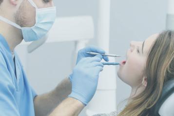 dentist looking in patient mouth