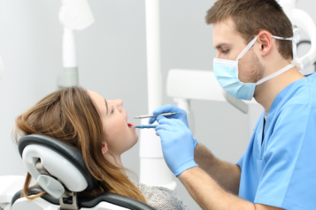 Dentist performing a check up on a patient