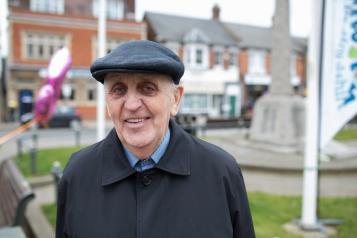 Man stood in front of a Healthwatch banner