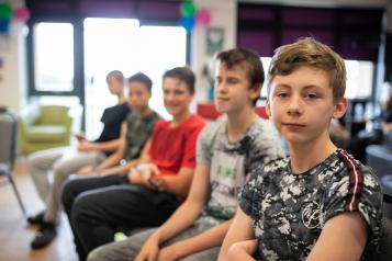 Group of young boys sitting in a row