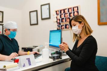 photo of person with medical professional with face mask on